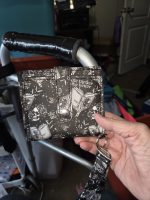 Handmade black-and-white gothic skull wristlet wallet with snap-tab closure and matching strap