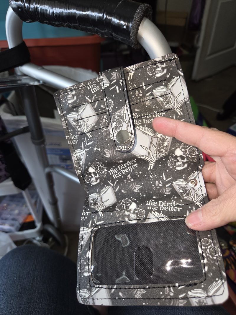 Open gothic skull wristlet wallet showing card slots and clear ID window