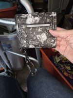 Back of gothic skull wristlet wallet with silver zipper pocket and detachable matching wrist strap