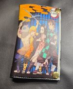 Handmade Mini Draco Demon Slayer DVD cover bifold wallet featuring colorful anime character artwork and gold-tone magnetic snaps.