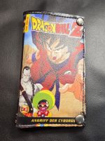 Handmade Mini Draco Dragon Ball Z DVD cover bifold wallet featuring Goku, colorful anime artwork and silver-tone magnetic snaps.