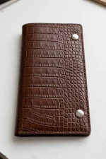 Mini Draco Bifold Wallet sewing pattern with examples of handmade compact bifold wallets in different fabrics.