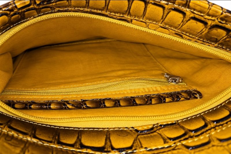Fully lined Burcham Crossbody Purse interior featuring slip pocket, zipper pocket and built-in key fob