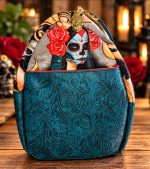 Side view of handmade sugar skull bowler bag with teal floral embossed vinyl